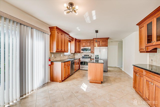 12 Carriage Dr, Piscataway, NJ 08854 - kitchen with stainless steel appliances, tasteful backsplash, a center island, a sink, and brown cabinets
