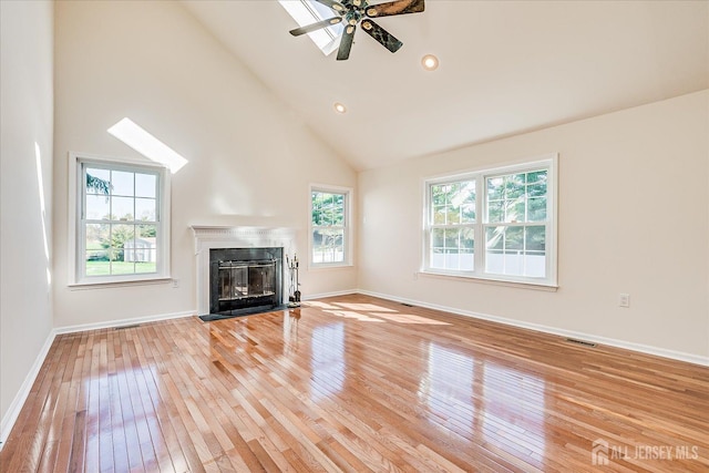 12 Carriage Dr, Piscataway, NJ 08854 - unfurnished living room with light wood-type flooring, a fireplace with flush hearth, high vaulted ceiling, baseboards, and ceiling fan
