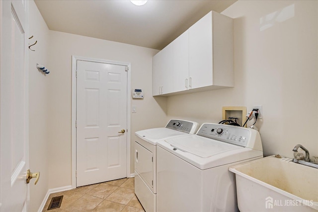 12 Carriage Dr, Piscataway, NJ 08854 - clothes washing area with independent washer and dryer, cabinet space, baseboards, and light tile patterned flooring