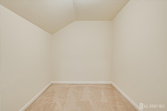 12 Carriage Dr, Piscataway, NJ 08854 - empty room with lofted ceiling, light carpet, and baseboards