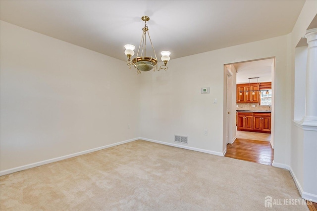 12 Carriage Dr, Piscataway, NJ 08854 - carpeted spare room with a chandelier and baseboards