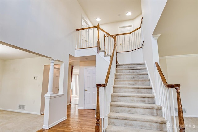 12 Carriage Dr, Piscataway, NJ 08854 - staircase with a towering ceiling, baseboards, decorative columns, and wood finished floors