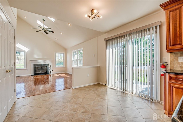 12 Carriage Dr, Piscataway, NJ 08854 - unfurnished living room featuring light tile patterned flooring, a fireplace with flush hearth, lofted ceiling, a skylight, and recessed lighting