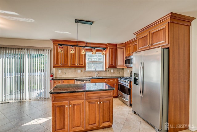 12 Carriage Dr, Piscataway, NJ 08854 - kitchen featuring appliances with stainless steel finishes, light tile patterned flooring, brown cabinetry, and a center island