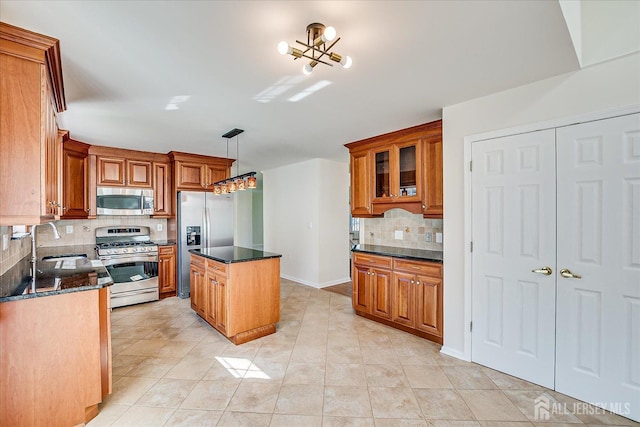 12 Carriage Dr, Piscataway, NJ 08854 - kitchen with appliances with stainless steel finishes, a sink, and brown cabinets