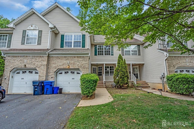 242 Hawthorne Rd, North Brunswick, NJ 08902 - multi unit property featuring asphalt driveway, a garage, brick siding, a front lawn, and covered porch