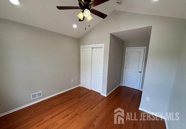 unfurnished bedroom featuring visible vents, recessed lighting, baseboards, and wood finished floors
