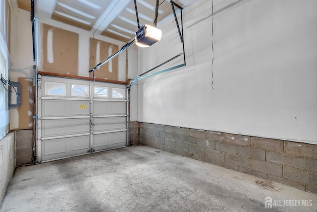 242 Hawthorne Rd, North Brunswick, NJ 08902 - garage with a garage door opener and concrete block wall