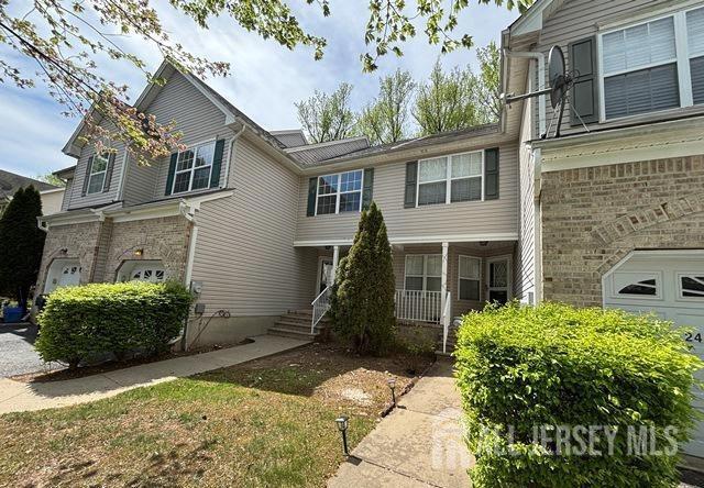 242 Hawthorne Rd, North Brunswick, NJ 08902 - view of front of house with covered porch and brick siding
