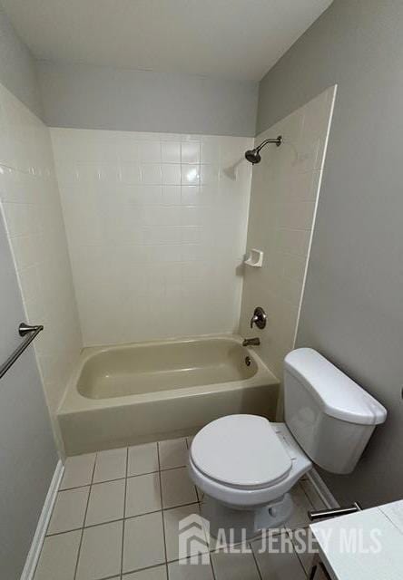 full bath with toilet, tile patterned flooring, and bathtub / shower combination