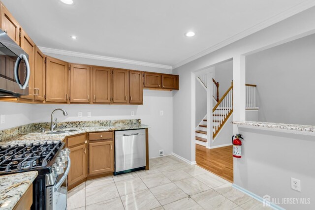 242 Hawthorne Rd, North Brunswick, NJ 08902 - kitchen featuring appliances with stainless steel finishes, crown molding, light stone counters, recessed lighting, and brown cabinets