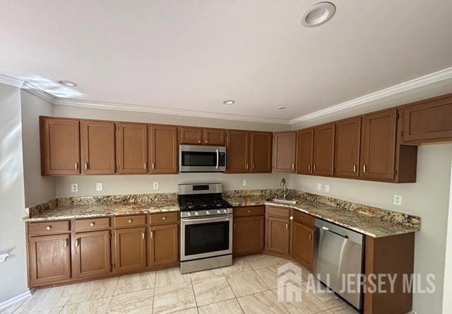 kitchen featuring crown molding, stainless steel appliances, and brown cabinetry
