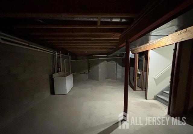242 Hawthorne Rd, North Brunswick, NJ 08902 - unfinished basement with washing machine and clothes dryer and stairs