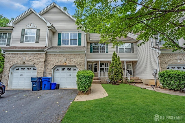 242 Hawthorne Rd, North Brunswick, NJ 08902 - view of property with driveway, a front yard, a garage, and brick siding