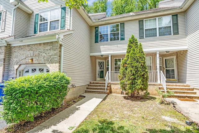 242 Hawthorne Rd, North Brunswick, NJ 08902 - view of front of home with a garage and a porch