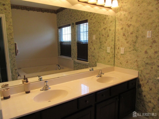 bathroom with a washtub and vanity