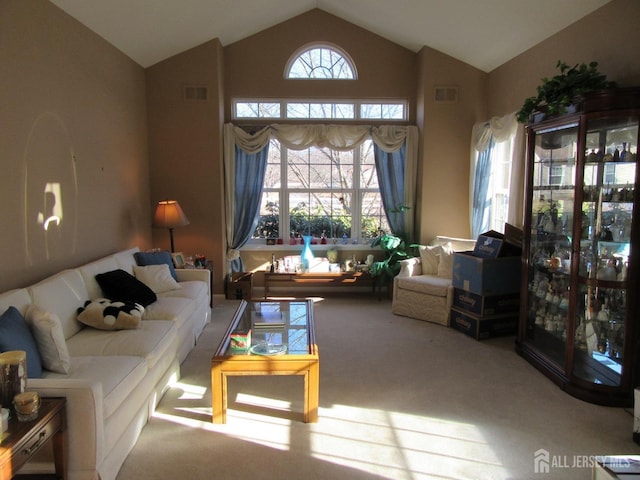 living room featuring light carpet and high vaulted ceiling