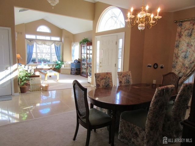 dining space featuring an inviting chandelier, light tile patterned floors, and high vaulted ceiling