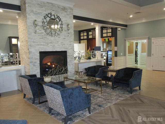 living room with parquet flooring, ornamental molding, and a fireplace