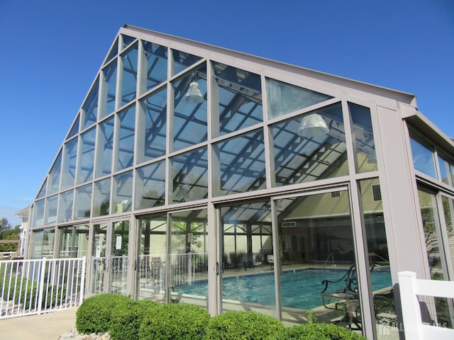 exterior space with a community pool and a lanai