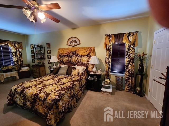 carpeted bedroom featuring ceiling fan