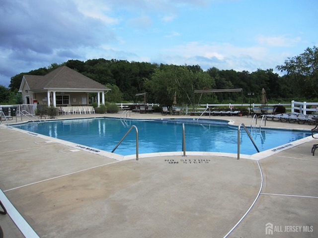 view of swimming pool with a patio area