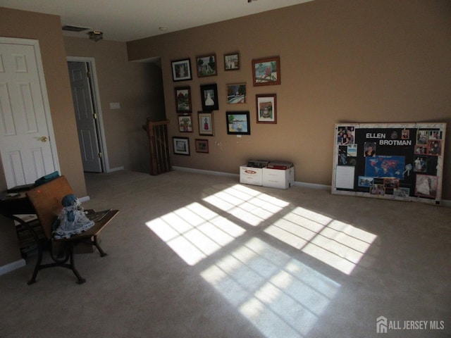 living area with light colored carpet