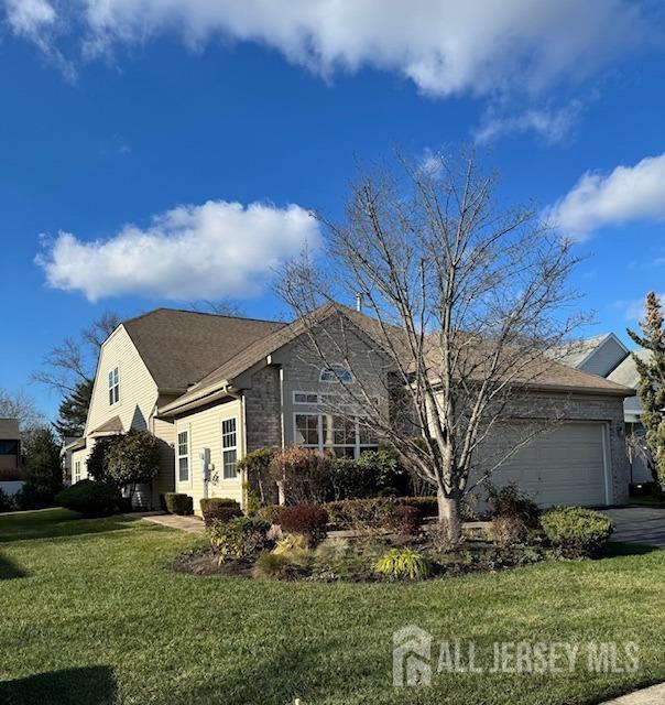 ranch-style house with a garage and a front yard