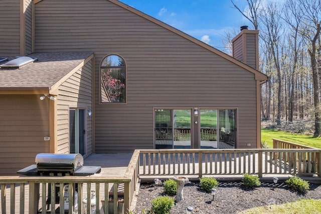 view of property exterior featuring a deck and a chimney