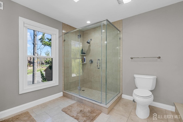 bathroom with baseboards, a shower stall, toilet, tile patterned floors, and recessed lighting