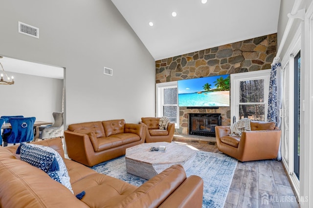 living area with high vaulted ceiling, a fireplace, a chandelier, wood finished floors, and recessed lighting