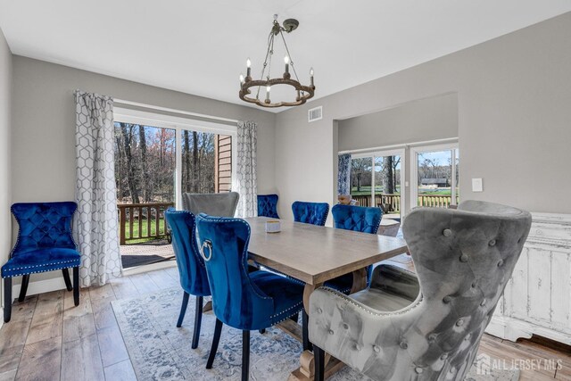 dining area featuring a chandelier and hardwood / wood-style floors