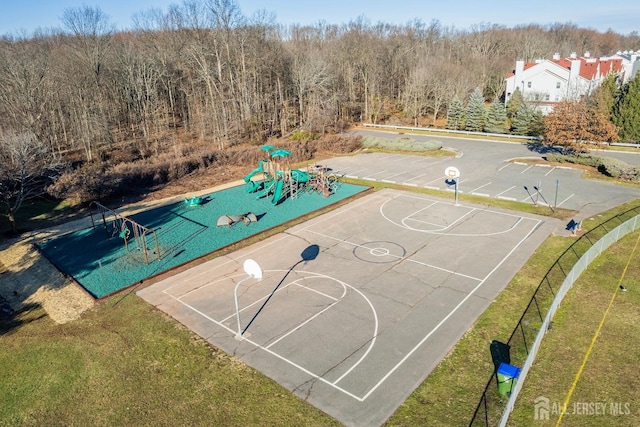 view of sport court featuring community basketball court, a lawn, and playground community