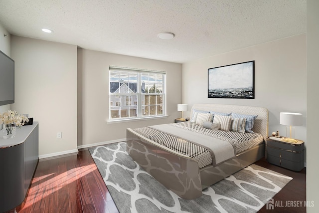 bedroom featuring wood finished floors, a textured ceiling, baseboards, and recessed lighting