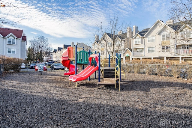 community playground featuring a residential view and fence