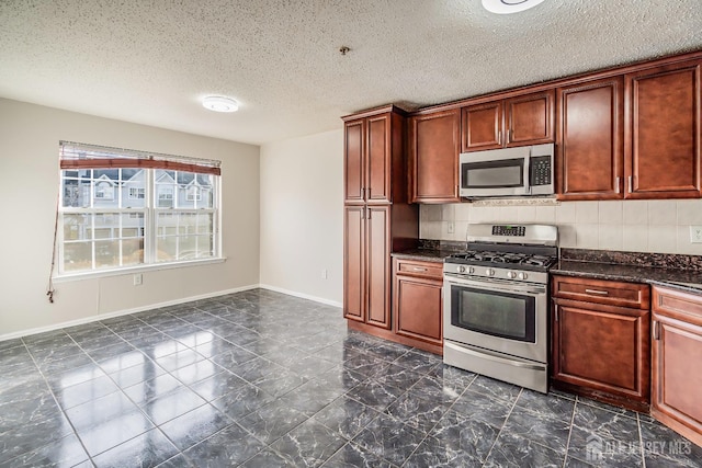 kitchen featuring stainless steel appliances, dark marble finish floors, a textured ceiling, baseboards, and tasteful backsplash