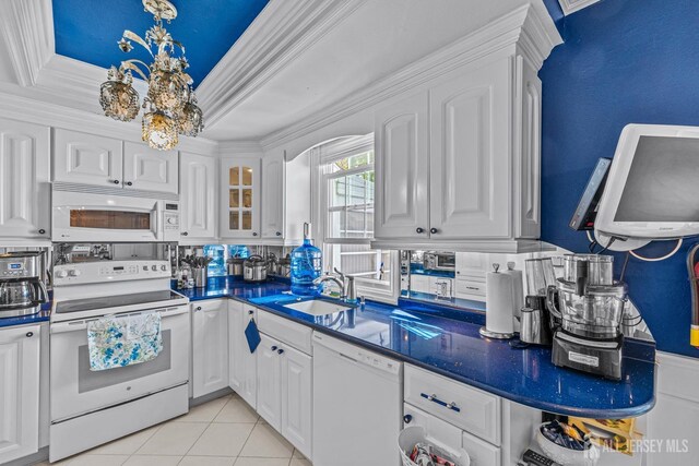 kitchen featuring ornamental molding, white appliances, sink, light tile patterned floors, and white cabinetry