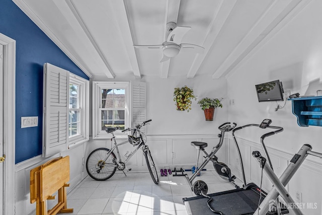 workout room with ceiling fan, light tile patterned floors, and lofted ceiling