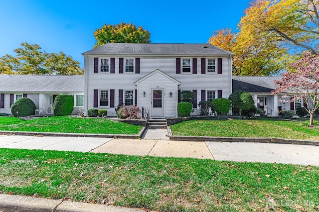 colonial-style house with a front yard