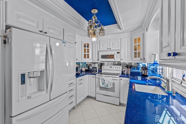 kitchen with white cabinetry, sink, white appliances, a tray ceiling, and light tile patterned floors