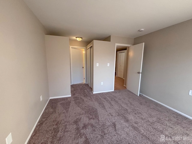 unfurnished bedroom featuring carpet flooring and baseboards