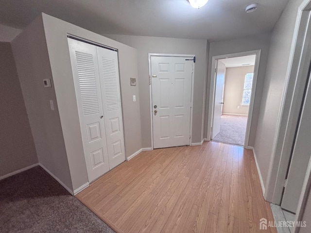 foyer featuring light wood-type flooring and baseboards