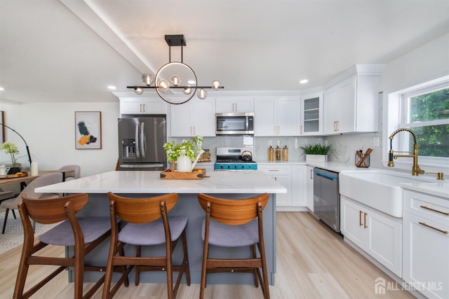 35 Evergreen Ave, Fords, NJ 08863 - kitchen with stainless steel appliances, a sink, tasteful backsplash, white cabinetry, and light wood finished floors