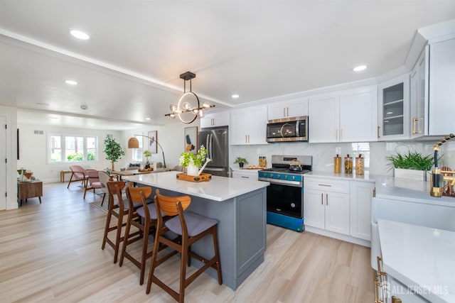 35 Evergreen Ave, Fords, NJ 08863 - kitchen featuring stainless steel appliances, light wood finished floors, light countertops, open floor plan, and a kitchen breakfast bar