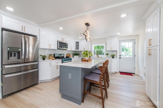 35 Evergreen Ave, Fords, NJ 08863 - kitchen with stainless steel appliances, white cabinetry, a kitchen breakfast bar, and recessed lighting
