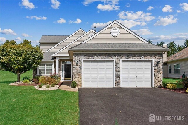 view of front of house with a garage and a front lawn