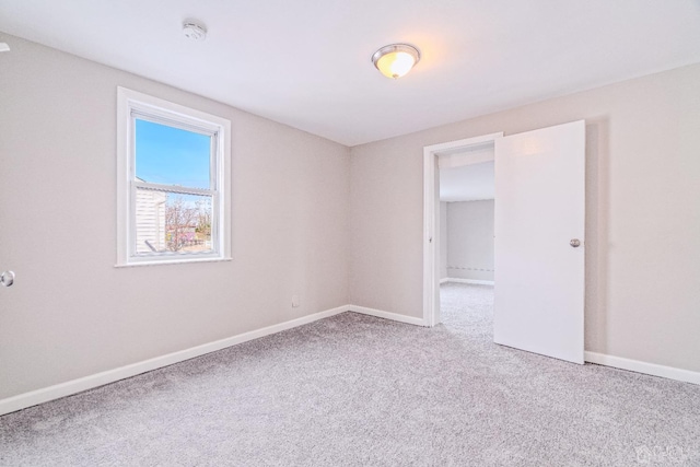 spare room with carpet flooring and baseboards