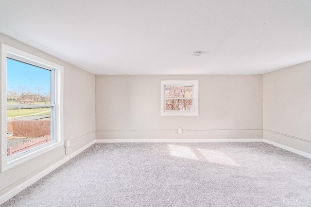 carpeted empty room with baseboards