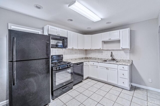 kitchen featuring black appliances, backsplash, white cabinetry, and sink