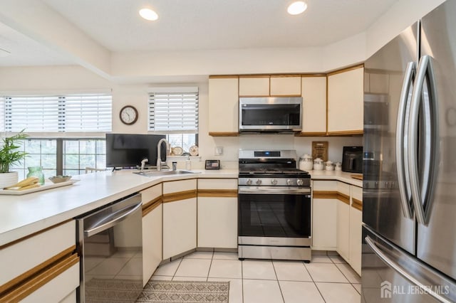 kitchen featuring light countertops, a sink, and appliances with stainless steel finishes